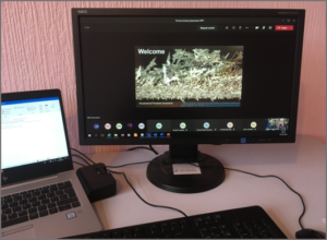 Photo showing laptop monitor with AFCP Pyro-processing Symposium introductory slide