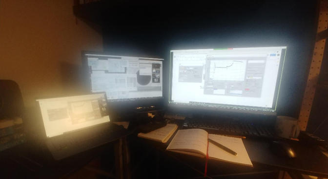 Photo of Alex's remote-control set-up from home, with Zoom open and two control screens (copious amounts of coffee not pictured).