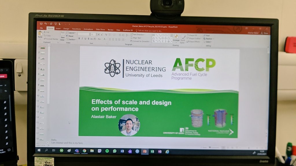 Photo of a computer monitor with a PowerPoint presentation open. The presentation title is "Effects of scale and design on performance" and is presented by Alastair Baker of the University of Leeds.