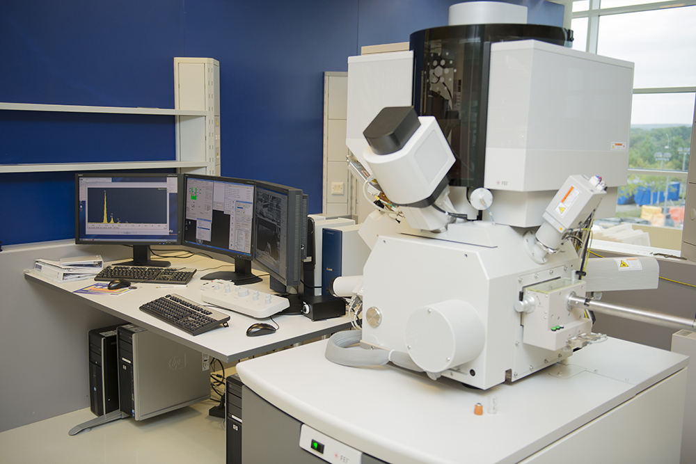 Photograph of computer monitors and equipment sitting on a white desk in front of a blue wall. This NNL equipment is part of the user access call.