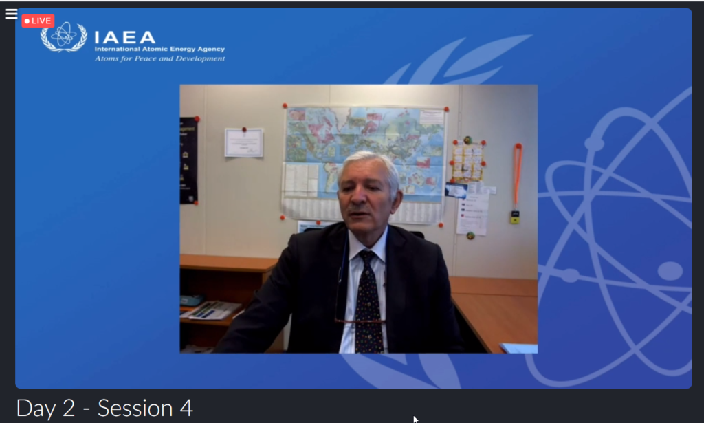 Screenshot of Christophe Xerri, situated in front of a blue background with IAEA logo, while he presented at AFCP's Quarterly Technical Meeting.